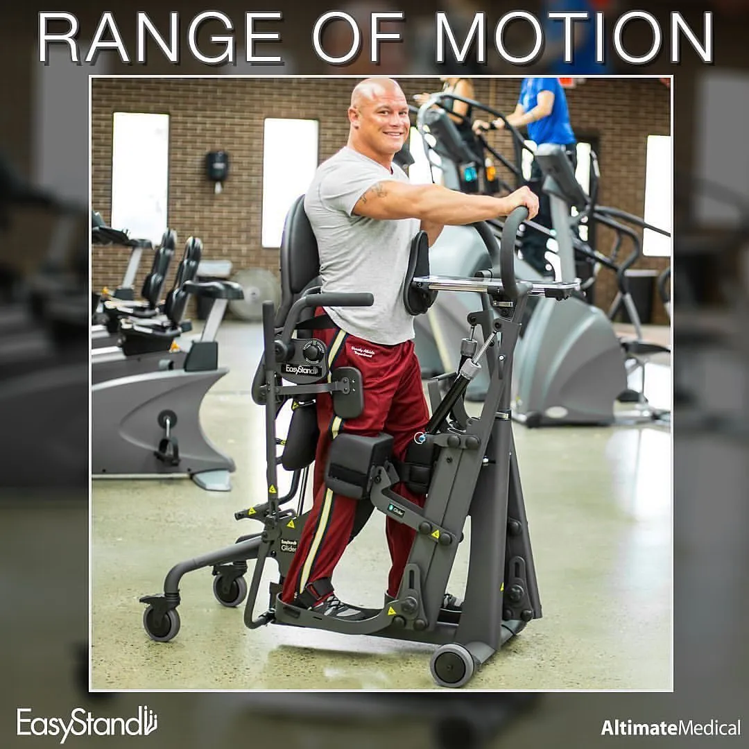 A smiling man is working out upright in the gym with the help of the EasyStand Glider.