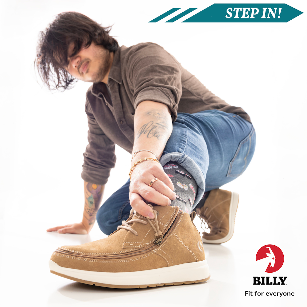 Young boy shows off his shoes to the camera, displaying the unique zipper design by BILLY Footwear that allows for easy wearing.