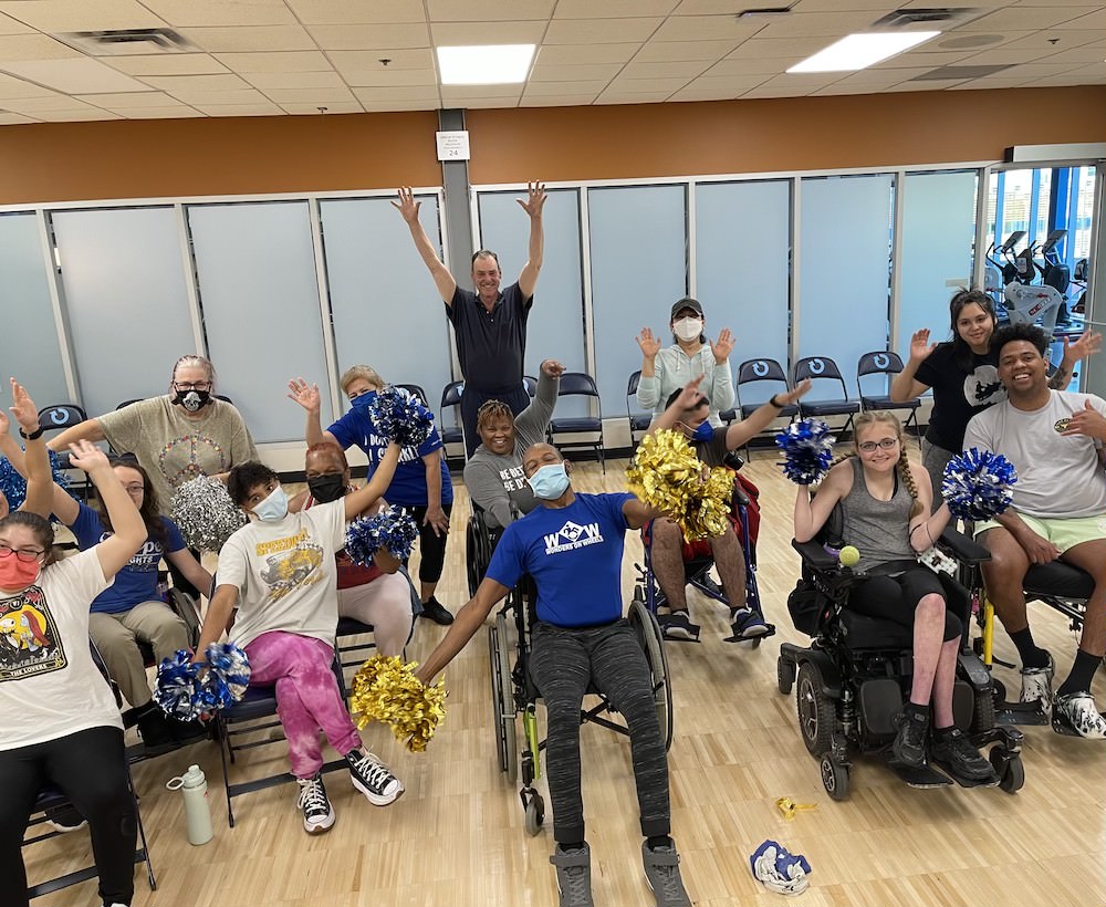 It's all good vibes and pom poms for Justin Graham of WOW Wonders on Wheels and his seated fitness class.