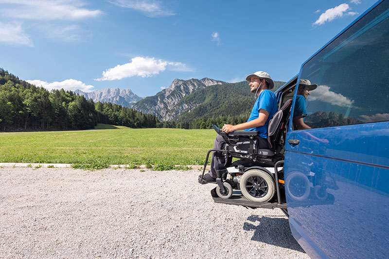 Man leaving an accessible vehicle while on a road trip stop in the mountains.