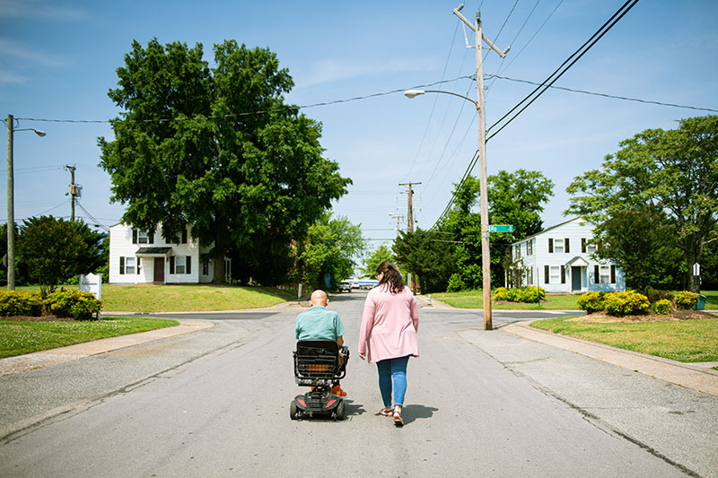 Affordable Housing: a man and woman on street in neighborhood