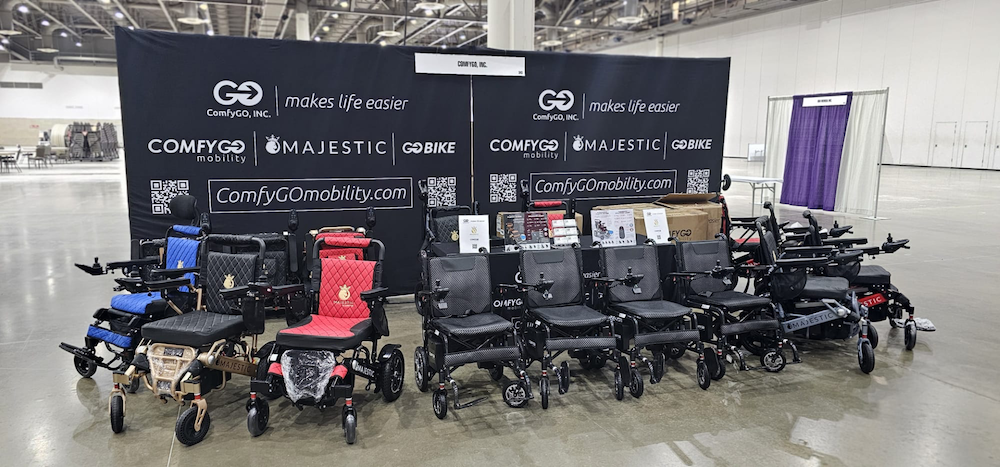 A ComfyGO multi-colored row of ComfyGO mobility devices are lined-up in the ComfyGO booth at Abilities Expo.