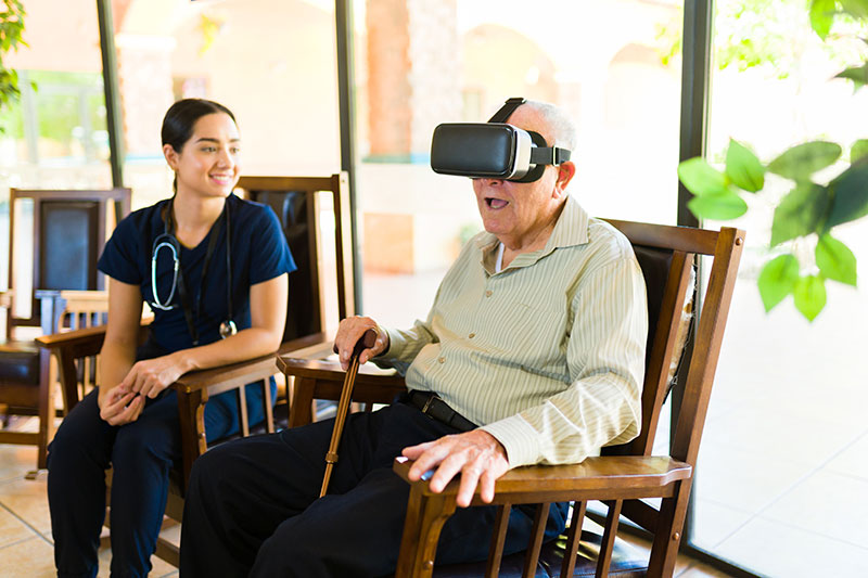 Nurse shows a man technology on a device