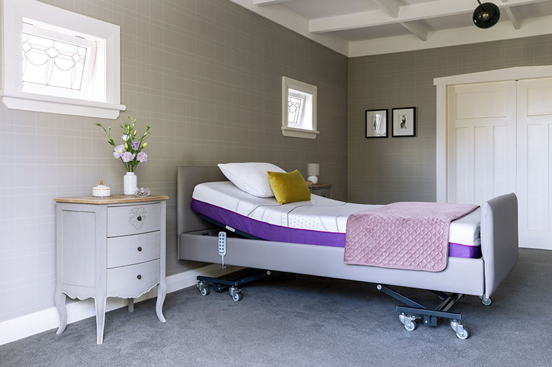 An icare bed is slightly inclined in a home bedroom setting.