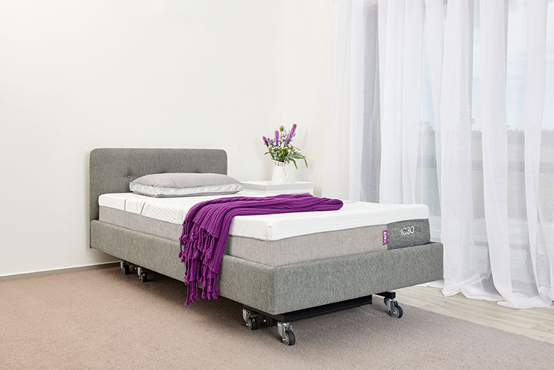 Two twin icare beds are side-by-side with the one on the right elevated.