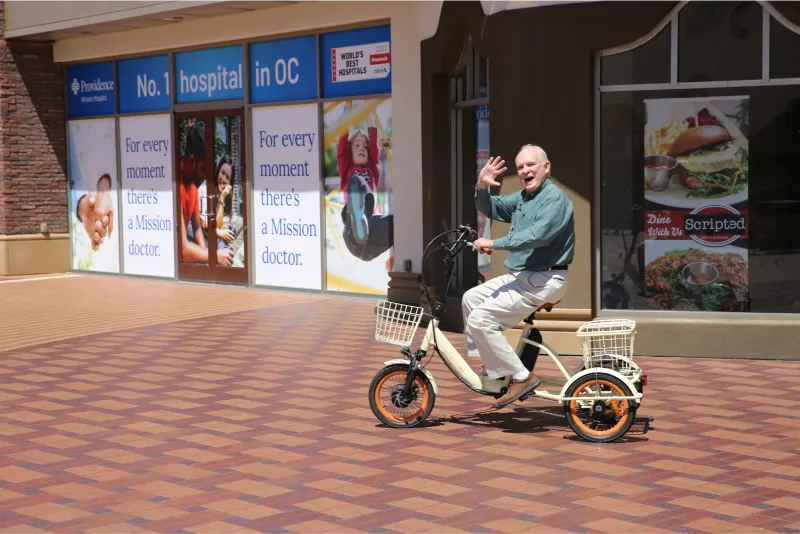 A man waves from his sixthreezero e-bike.